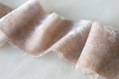 dusty rose silk velvet ribbon on a wooden spool