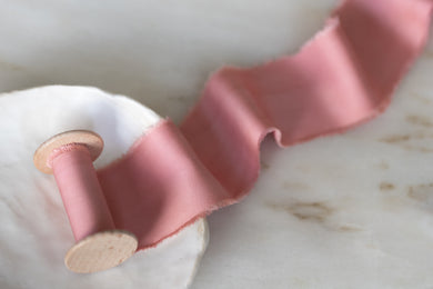 handmade and hand dyed with a hand torn frayed edge on a wooden spool