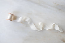 Load image into Gallery viewer, close up of a narrow, delicate cream silk chiffon ribbon from Nettle and Silk