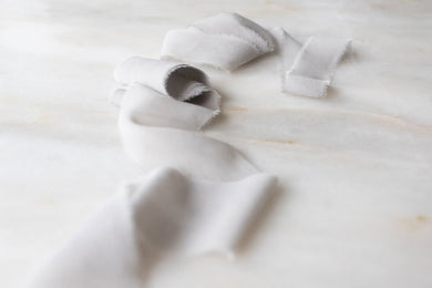 pale grey silk ribbon on a wooden spool