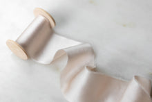 Load image into Gallery viewer, Pale blush pure silk ribbon, handmade and hand dyed in Oregon. Sold by the yard on a wooden spool